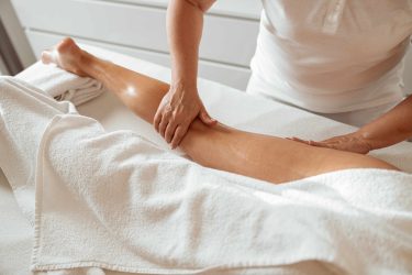 Female Client Receiving Leg Massage At Wellness Center