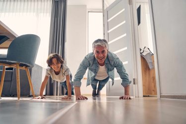 Father And Son Doing Sport At Home