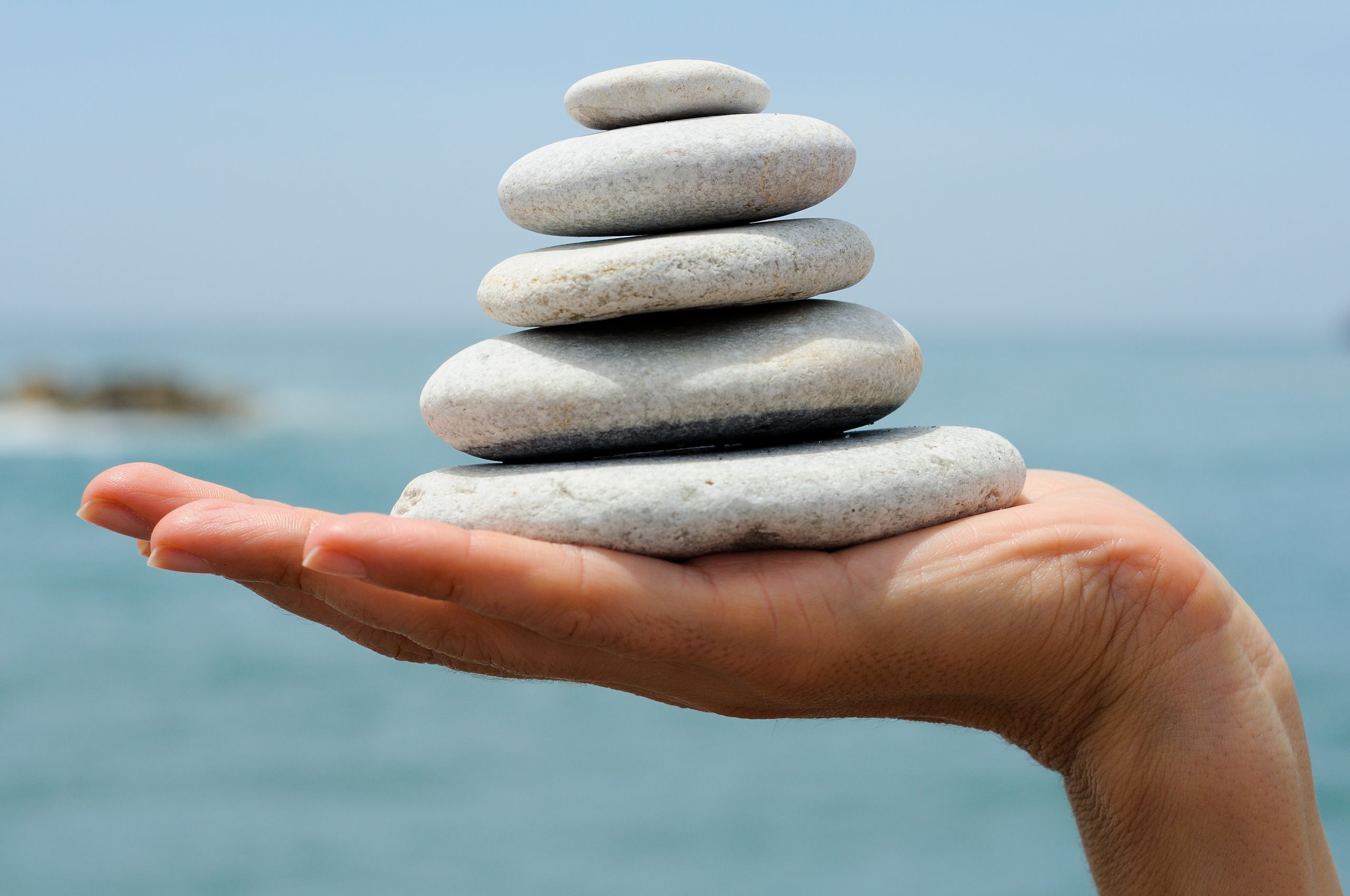 Gravel Pile In Woman's Hands With Sea Background