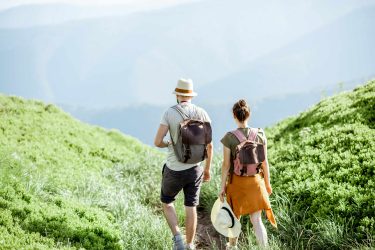 Couple Traveling In The Mountains
