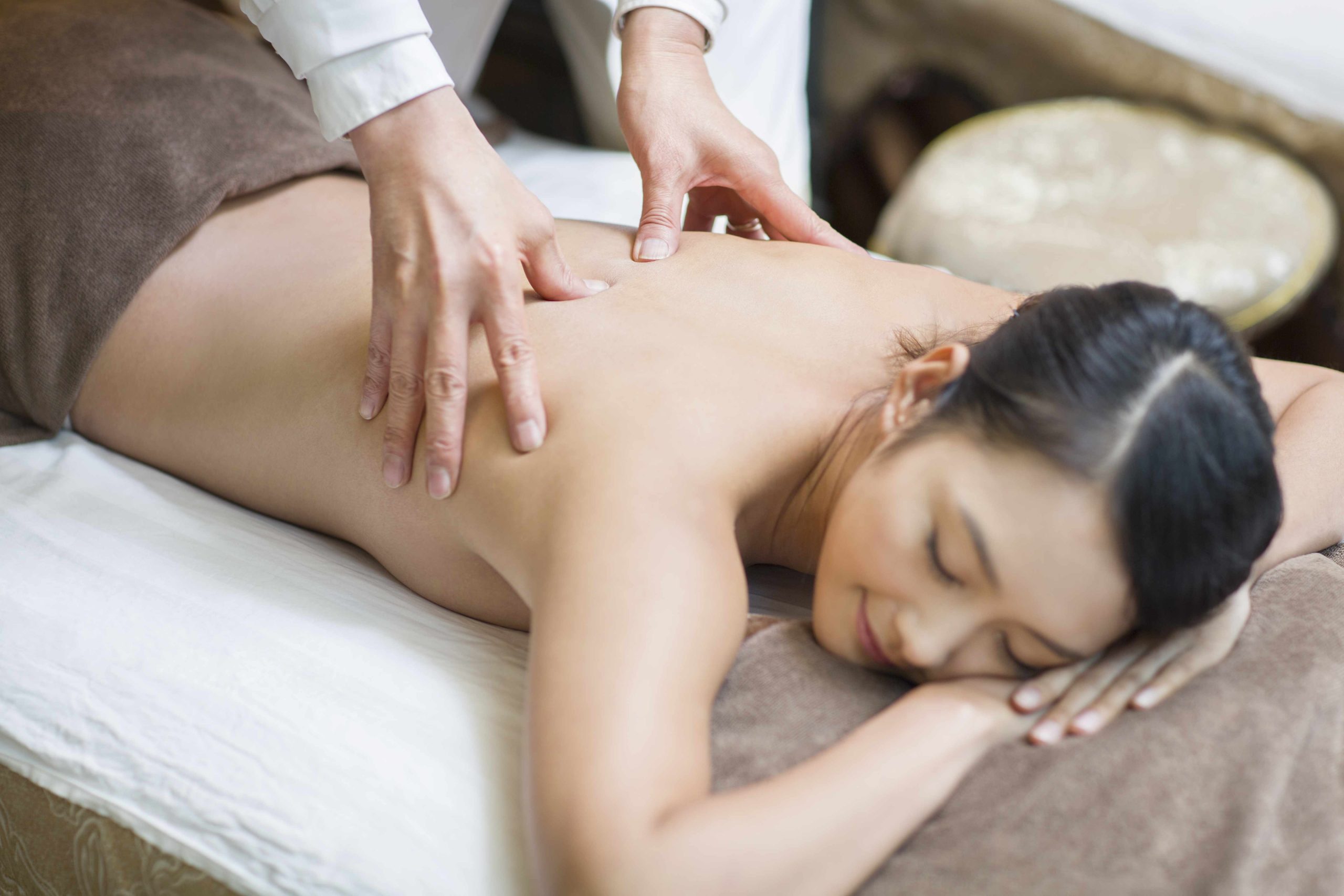 Young Chinese Woman Receiving Shiatsu Massage