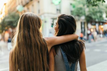 Rearview Of A Couple Of Female Friends