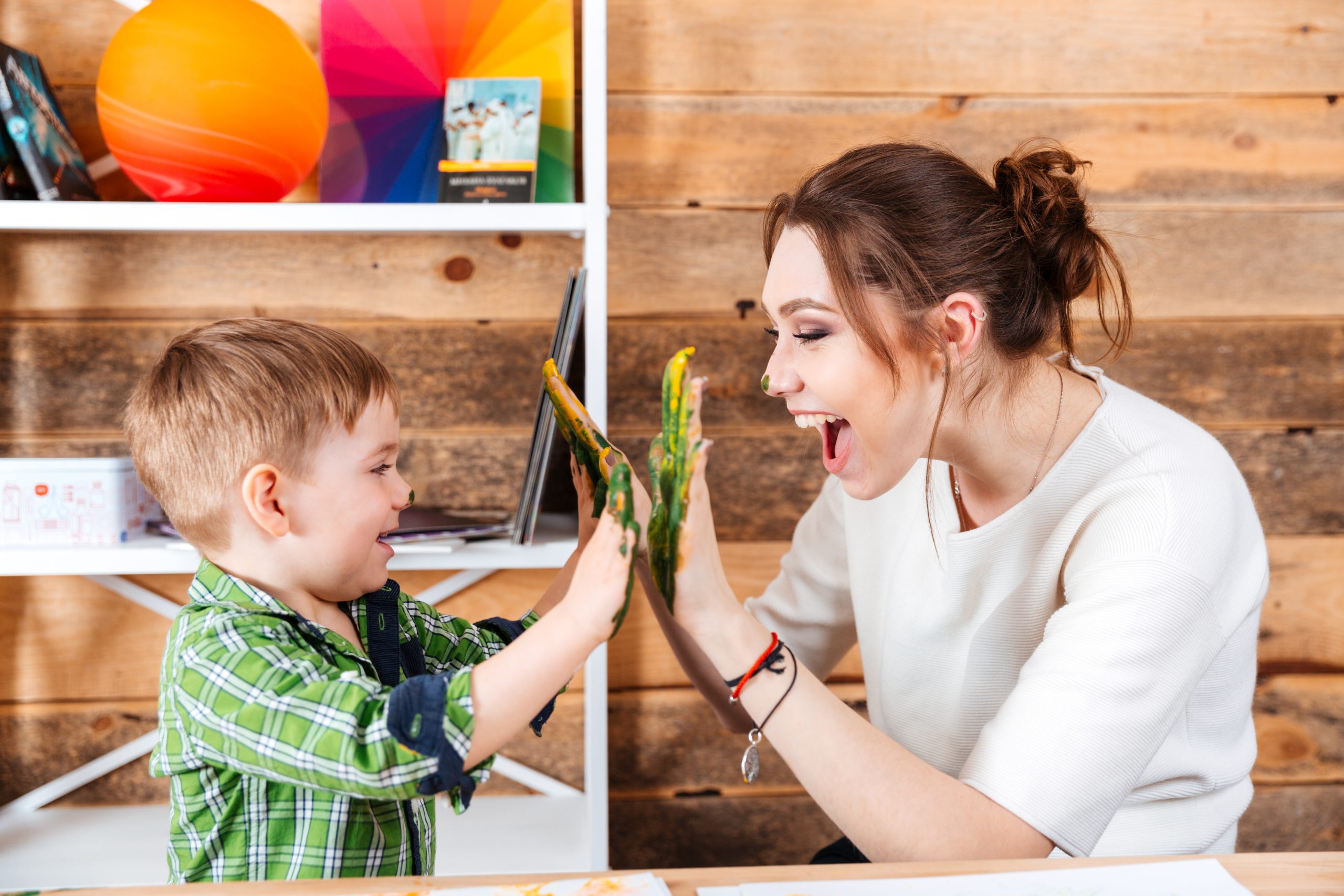 Mother And Little Son Giving High Five With Painted Hands